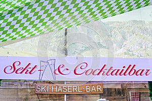 Wooden signs from at the german oktoberfest referring to champagne-sekt and cocktails area where people can buy alcohol