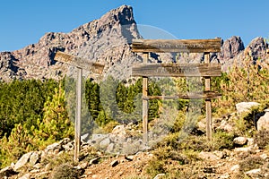 Wooden signs and mountains in Forest d'Albertacce in Corsica