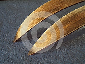 Wooden ski tips, one pair. The underside or inside of the skis, treated with ski wax to improve glide on snow and crust.