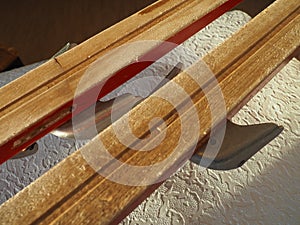 Wooden ski tips, one pair. The underside or inside of the skis, treated with ski wax to improve glide on snow and crust.