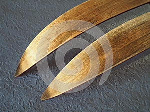 Wooden ski tips, one pair. The underside or inside of the skis, treated with ski wax to improve glide on snow and crust.
