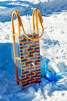 Wooden sledge in the snow. on blue and white background.