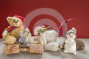 Wooden sleigh with a teddy bear, snowman, pixy, candy cane, Christmas baubles, children, pine cones and gifts