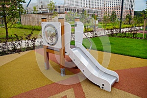 A wooden slide of white blue color on the playground in kindergarten on a clear sunny day.