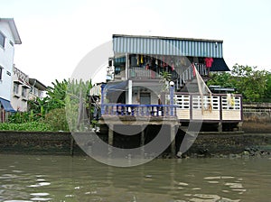 Wooden slums on stilts the riverside of Chao Praya River in Bangkok, Thailand