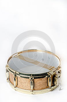 Wooden snare drum with gold rims