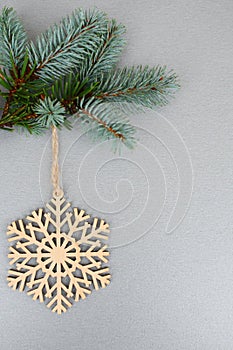 Wooden snowflake on xmas tree branch