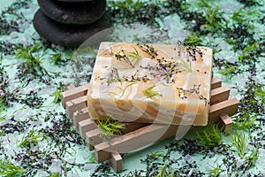 Wooden Soap Holder with Handmade Almond Scented Goats Milk Bar Soap and stacked Basalt Stones decorated with flower sprinkles