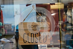 Wooden sorry we are closed sign board wood on windows shop restaurant cafe store signboard