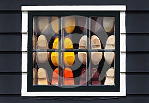 Wooden souvenir clogs behind a window