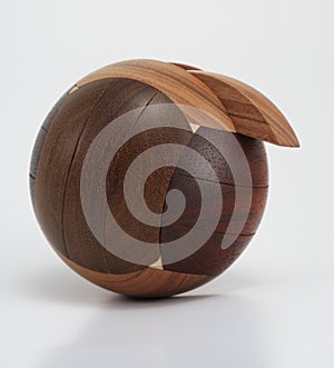 Wooden sphere puzzle on white background photo