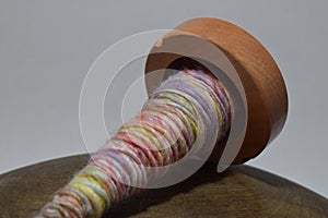 Wooden spindle with hand spun yarn