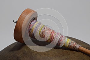 Wooden spindle with hand spun yarn