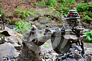 A wooden spinner lies on strange stone structures in the forest