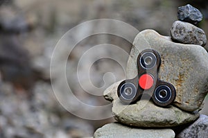 A wooden spinner lies on strange stone structures in the forest