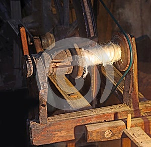 wooden spinning wheel for balls of wool or cotton used by weavers of the past