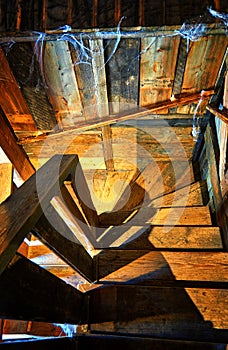 Wooden spiral staircase in an old wooden house