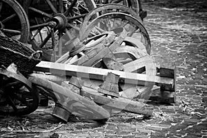 Wooden spoked wheels laying in a pile