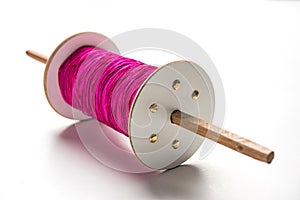 Wooden Spool or chakri/reel/fikri with pink or white thread