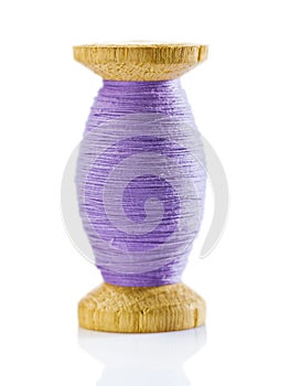Wooden spool with thread