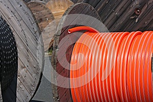 Wooden spools with black and orange cables