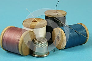 wooden spools with colored cotton threads for sewing,