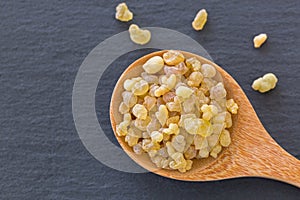 Wooden spoon of Aromatic yellow resin gum from Sudanese Frankincense tree, incense made of Boswellia sacra tree photo