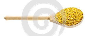Wooden spoon with bulgur wheat groats isolated
