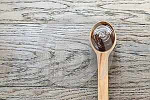 Wooden spoon of chocolate cream