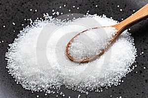 Wooden spoon with crystalline fructose close up