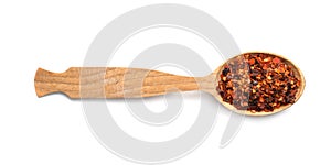 Wooden spoon with dried chopped chili pepper on white background. Different spices