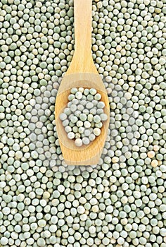 Wooden spoon and dried green split peas