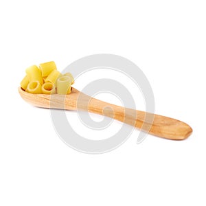 Wooden spoon filled with dry ditalini pasta over isolated white background