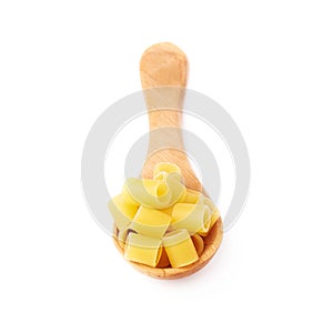 Wooden spoon filled with dry ditalini pasta over isolated white background