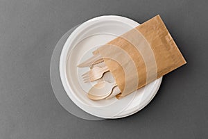 Wooden spoon, fork and knife on paper plate