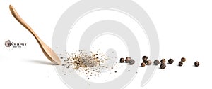 Wooden spoon ground black pepper and ground black pepper on white background