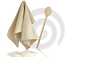 Wooden spoon and kitchen towel