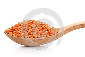 Wooden spoon with lentils isolated on white background.