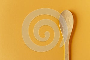 Wooden spoon on a light background. Close-up