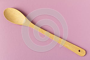 Wooden spoon on a light background. Close-up