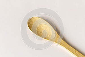 Wooden spoon on a light background. Close-up