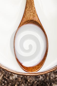 Wooden spoon with milk