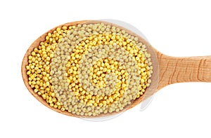 Wooden spoon with millet gruel on white background.