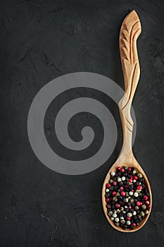 Wooden spoon with mix of peppers