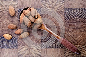 wooden spoon with nuts snack salted almonds wooden cooking Board top view