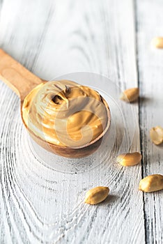 Wooden spoon of peanut butter