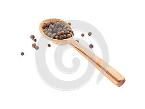 A wooden spoon with peppercorns