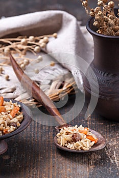 Wooden spoon with rice pilaf on the kitchen table