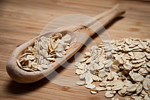 A wooden spoon with rolled oats