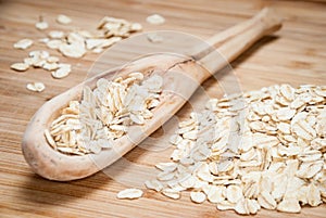 A wooden spoon with rolled oats